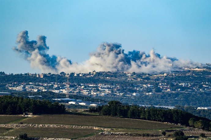 BEIJING, Dec. 27, 2023  -- Smoke rises from Lebanese village of Marwahin following Israeli bombardment in southern Lebanon, as seen from northern Israel, on Dec. 26, 2023. Two Hezbollah fighters and a member of the Lebanese Civil Defense were killed on 