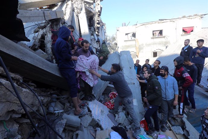 December 30, 2023, Nuseirat, Gaza Strip, Palestinian Territory: Residents and civil defense teams conduct search and rescue operation under the rubbles following an Israeli attack on Al-Wawi family building in Nuseirat Camp, Gaza Strip, on December 30, 20