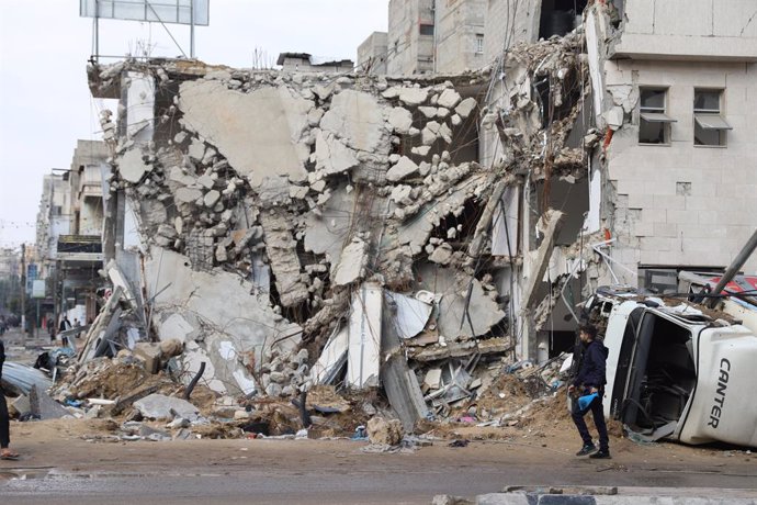 GAZA, Jan. 2, 2024  -- A man walks past a destroyed building in Gaza City, on Jan. 2, 2024. The death toll of Palestinians has exceeded 22,000 after the outbreak of the Israel-Hamas conflict on Oct. 7, 2023, the Hamas-run Health Ministry said on Tuesday.