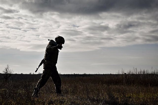 December 28, 2023, Ukraine: UKRAINE - DECEMBER 28, 2023 - A serviceman of an artillery unit of the 128th Mountain Assault Brigade of the Ukrainian Ground Forces carries a shell during a training session.