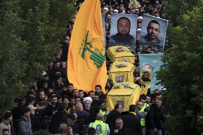 KAFR KILA (LEBANON), Jan. 2, 2024  -- People attend a funeral of three Hezbollah fighters in Kafr Kila, Lebanon, on Jan. 2, 2024. Three Hezbollah fighters were killed on Monday in confrontations with Israeli forces on the border area in southern Lebanon