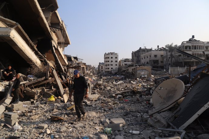 GAZA, Jan. 8, 2024  -- People are seen among the rubble of destroyed buildings in the northern Gaza Strip town of Beit Lahia, on Jan. 8, 2024. The Palestinian death toll from the ongoing Israeli attacks on the Gaza Strip exceeded 23,000, the Gaza-based 