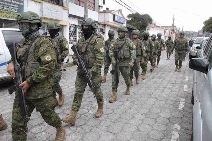 QUITO, Jan. 10, 2024  -- Ecuadorian troops patrol in Quito, Ecuador, Jan. 9, 2024. Ecuadorian President Daniel Noboa on Tuesday declared "internal armed conflict" and mobilized the army to combat organized crime linked to drug trafficking, following an 