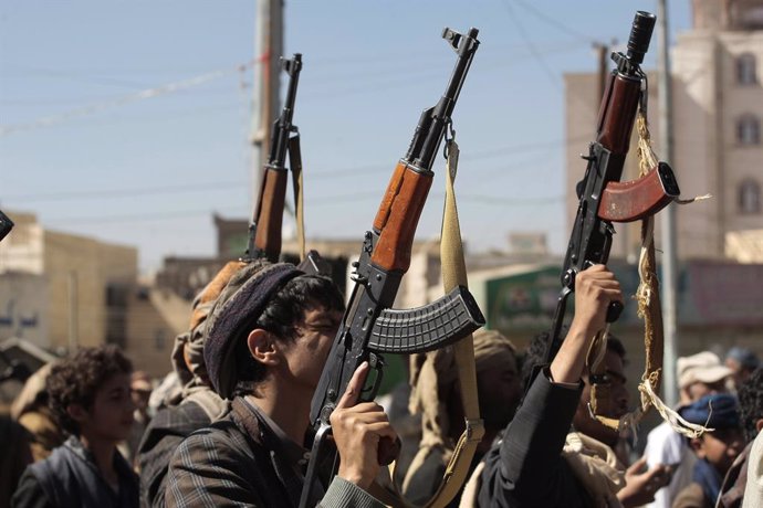 January 11, 2024, Sanaa, Sanaa, Yemen: Newly recruited Houthi fighters hold up a weapons and chanting slogans in a ceremony at the end of their training in Sanaa, Yemen..The head of Yemen's Houthi movement, Abdul-Malik al-Houthi, has cautioned the Unite
