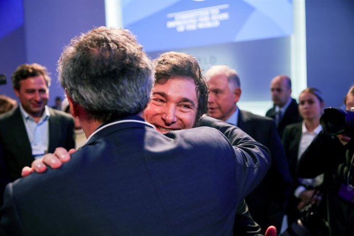 17 January 2024, Switzerland, Davos: Javier Milei, President of Argentina, is embraced by a participant after his speech at the World Economic Forum. 