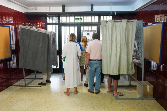 Archivo - Imagen de archivo de unos votantes en un colegio en Sevilla. 