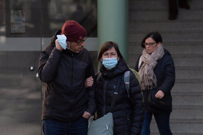Diverses persones amb mascarillas enfront de l'Hospital Clínic de Barcelona