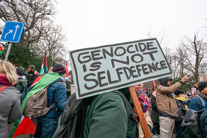 January 11, 2024, The Hague, Netherlands: A protester holds a placard during the International Court of Justice (ICJ) hearing. South Africa presented its case against the state of Israel during its three-hour session at the International Court of Justic