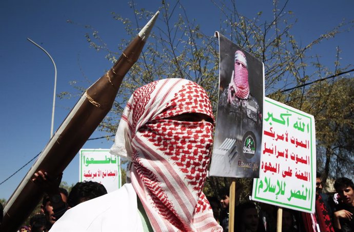 January 24, 2024, Sanaa, Sanaa, Yemen: A man wears traditional Palestinian keffiyeh in front of a mock missile and chants slogans anti-Israel and U.S.-led sustained airstrikes on Yemen during a demonstration in solidarity with the Palestinian people amid 