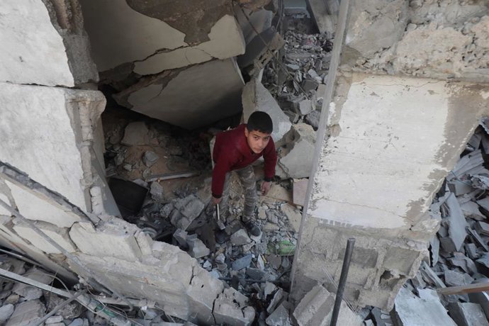 January 25, 2024, Nusairat, Gaza Strip, Palestinian Territory: Palestinians inspect destruction after an Israeli bombing of building  in Nusairat, Gaza on January 25, 2024. Several buildings were collapsed or heavily damaged after the attack. Abed R,Ima
