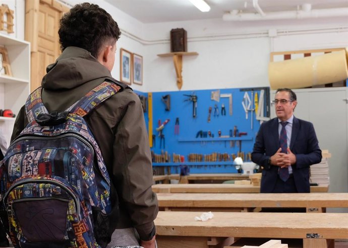 Archivo - El delegado de Desarrollo Educativo y Formación Profesional, y de Universidad, Investigación e Innovación, Miguel Briones, atiende a un alumno.