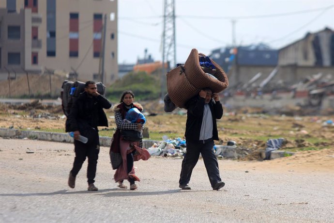 GAZA, Jan. 29, 2024  -- People leave their home after receiving evacuation orders from Israel in the southern Gaza Strip city of Khan Younis, on Jan. 29, 2024. The Hamas-run Health Ministry in Gaza said on Monday that the Palestinian death toll from the I