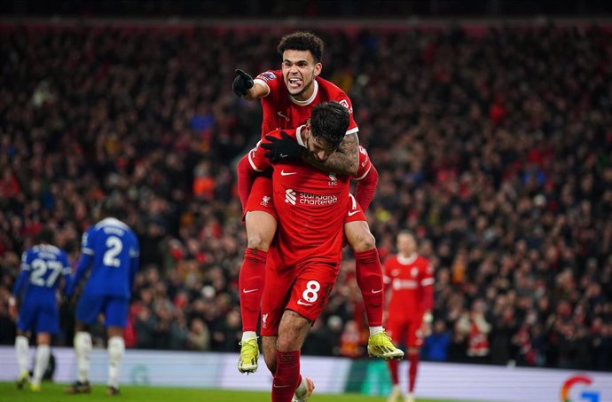 31 January 2024, United Kingdom, Liverpool: Liverpool's Dominik Szoboszlai (R) celebrates with team-mate Luis Diaz after scoring their side's third goal during the English Premier League soccer match between Liverpool and Chelsea at Anfield. Photo: Peter 
