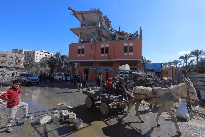 February 1, 2024, Dair El-Bakah, Gaza Strip, Palestinian Territory: Palestinians inspect the rubbles of demolished buildings after Israeli attacks as the building targeted in the attack and the surrounding buildings are damaged in Dair El-Balah, Gaza. Cas
