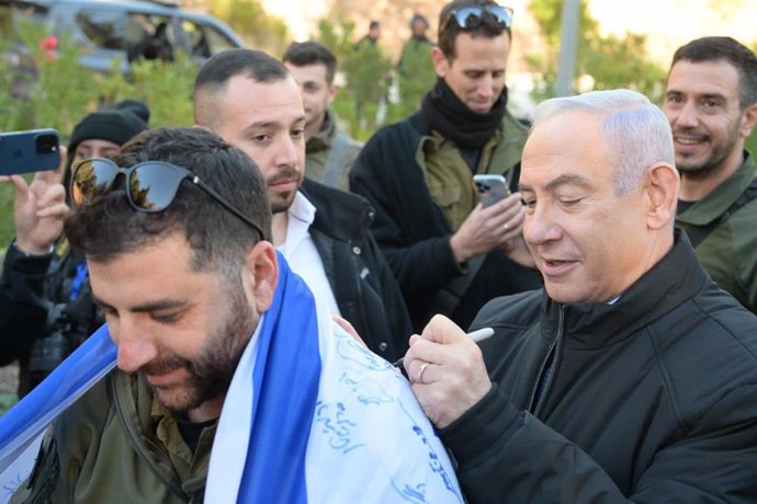 January 30, 2024, Eli, Israel: Prime Minister BENJAMIN NETANYAHU signs an Israeli flag as meets with reserve soldiers and commanders of the IDF Judea and Samaria Division, 43rd Battalion, in the Binyamin Brigade, in the community of Eli.