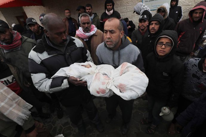 January 26, 2024, Dair El-Balah, Gaza Strip, Palestinian Territory: Palestinians who lost their loved ones mourn as bodies of the deceased are taken out of the mortuary of Al-Aqsa Hospital for burial in Dair El-Balah, Gaza.