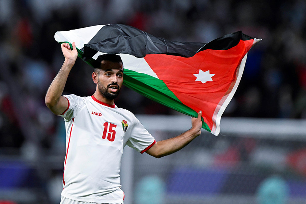06 February 2024, Qatar, Al-Rayyan: Jordan's Ibrahim Sadeh celebrates with his national flag after the AFC Asian Cup Semi Final soccer match between Jordan and South Korea at Ahmad bin Ali Stadium. Photo: -/Saudi Press Agency/dpa