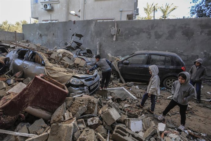 07 February 2024, Palestinian Territories, Rafah: Palestinian children look on as they inspect rubble and debris of destroyed houses and vehicles in the aftermath of an Israeli bombardment, amid the ongoing battles between Israel and the Palestinian mil