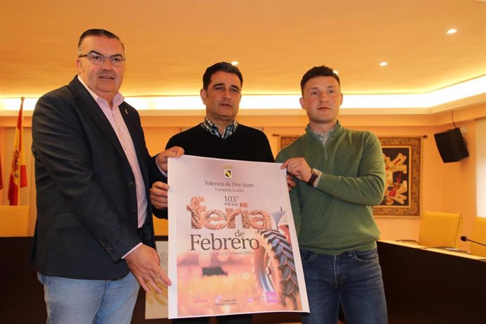 El alcalde de Valencia de Don Juan, Roberto Barrientos; el concejal de Ferias y Mercados, Ángel Pérez, y el vicepresidente primero de la Diputación de León, Roberto Aller, con el cartel de la 103 edición de la Feria de Febrero.