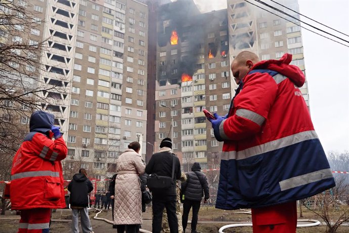 February 7, 2024, Kyiv, Ukraine: Emergency services stand near the site of a missile attack in a residential area of the city in Kyiv. Russia launched a missile strike on Kyiv, Ukraine, according to the statement from local authorities, more than 20 rocke
