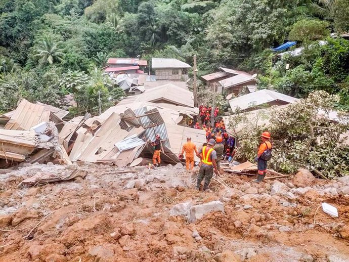 MANILA, Feb. 7, 2024  -- Rescuers work at the site of a landslide in Davao de Oro province in the southern Philippines, Feb. 7, 2024. Rescuers in the Philippines have recovered the bodies of six buried under mud and rocks from a landslide that crashed int