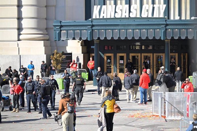 14 February 2024, US, Kansas City: Police clear the area of fans around the Kansas City Chiefs' Super Bowl victory rally after shots were fired near Union Station. One person was killed and several were wounded in a shooting in Kansas City, United States 