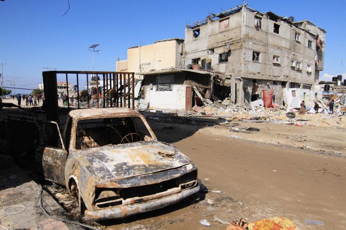 February 3, 2024, Khan Yunis, Gaza Strip, Palestinian Territory: Palestinians walk past destroyed buildings and streets in Khan Yunis in the southern Gaza Strip on February 3, 2024