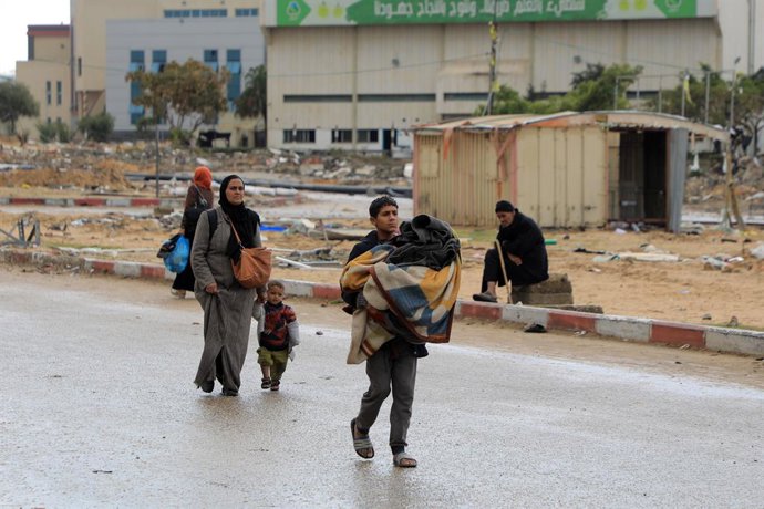 GAZA, Jan. 29, 2024  -- People leave their home after receiving evacuation orders from Israel in the southern Gaza Strip city of Khan Younis, on Jan. 29, 2024. The Hamas-run Health Ministry in Gaza said on Monday that the Palestinian death toll from the