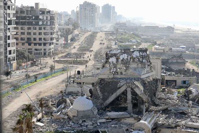 GAZA, Feb. 20, 2024  -- People are seen on a street with destroyed buildings in Gaza City, on Feb. 20, 2024. The Gaza-based Health Ministry said on Tuesday that the death toll in the Gaza Strip has risen to 29,195 with 69,170 others wounded as the Israe