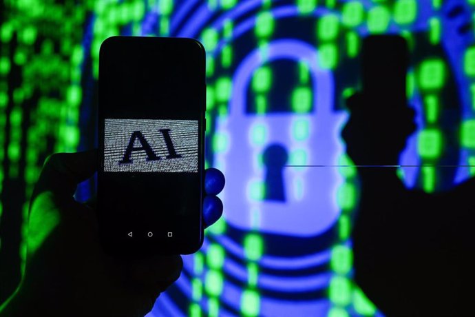 El símbolo de la Inteligencia Artificial (IA) aparece en un smartphone con líneas de código de fondo.