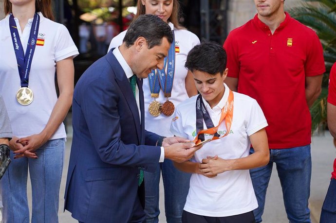 Archivo - El presidente de la Junta de Andalucía, Juanma Moreno conversa con la atleta María Pérez en un acto de homenaje a deportistas andaluces en octubre de 2023, en Sevilla. Archivo.