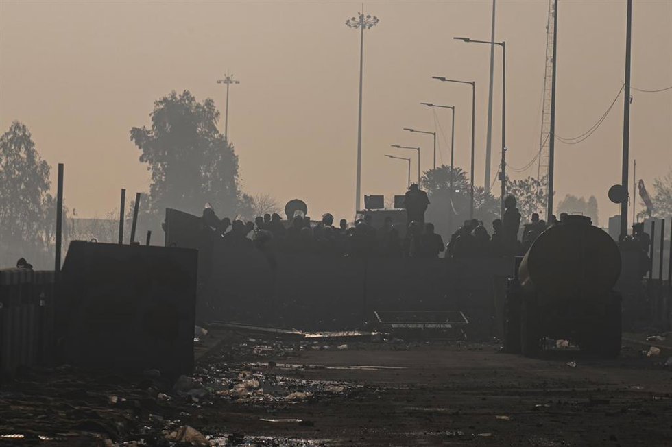 February 15, 2024, Shambhu, Punjab, India: Police officers stand guard behind the barricades on a national highway as the farmers are marching towards New Delhi for Minimum Support Price (MSP) for their crops which was promised to them in 2021 during th