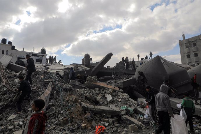 GAZA, Feb. 22, 2024  -- People are seen among the rubble after an Israeli airstrike in the southern Gaza Strip city of Rafah, on Feb. 22, 2024. The Palestinian death toll from the ongoing Israeli attacks on Gaza has risen to 29,410, with 69,465 others wou