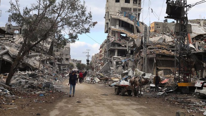 Archivo - Palestinos junto a edificios destruidos por los bombardeos del Ejército de Israel contra la ciudad de Beit Lahia, en el norte de la Franja de Gaza (archivo)