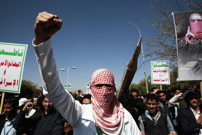 January 24, 2024, Sanaa, Sanaa, Yemen: A man wears traditional Palestinian keffiyeh in front of a mock missile and chants slogans anti-Israel and U.S.-led sustained airstrikes on Yemen during a demonstration in solidarity with the Palestinian people ami