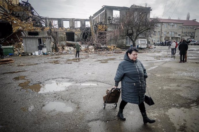 23 February 2024, Ukraine, Odessa: A local resident walks past a destroyed sewing factory in the port city of Odessa after a night-time drone attack. 