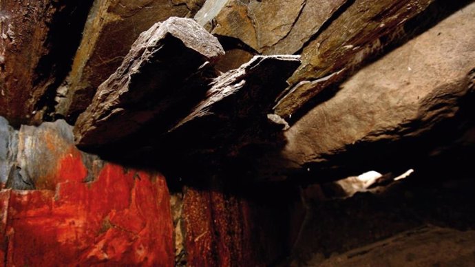 Detalle de la capa brillante de pigmento rojo que cubre las lajas del corredor de acceso a la cámara principal Del tholos de Montelirio