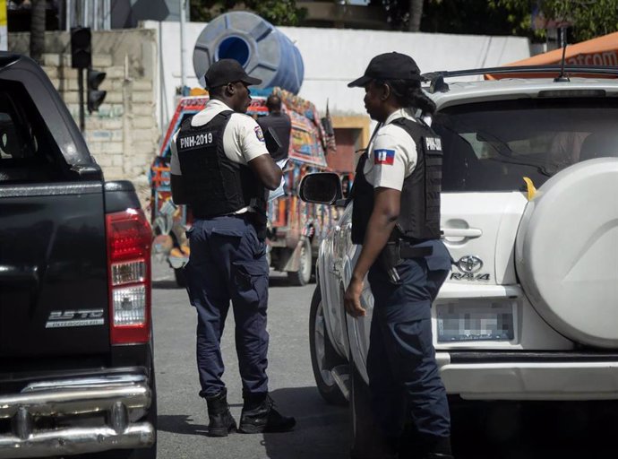 July 9, 2022: Haiti National Police officers check identifications at a checkpoint in Port-au-Prince on June 19, 2022.