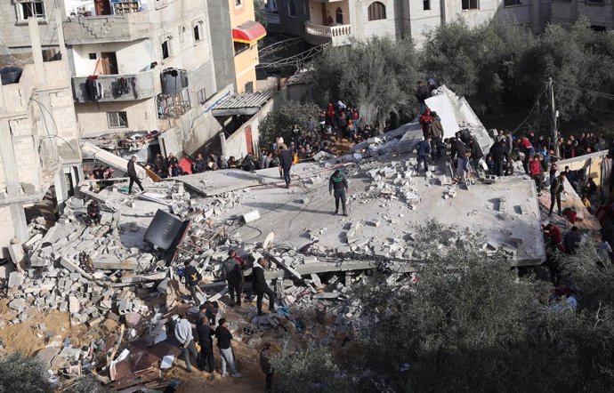 RAFAH, March 3, 2024  -- People gather around a destroyed building after an Israeli airstrike in the southern Gaza Strip city of Rafah, March 3, 2024. At least 30 Palestinians were killed and dozens of others wounded in Israeli overnight airstrikes in the