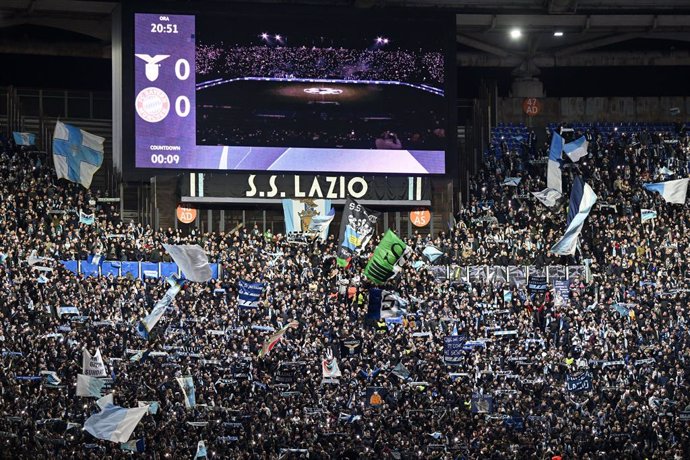 14 February 2024, Italy, Rome: Lazio fans wave flags during the UEFA Champions League round of 16 first leg soccer match between Lazio Roma and Bayern Munich at the Olympic Stadium. Photo: Sven Hoppe/dpa