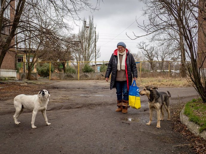 February 8, 2024, Nju-Jork, Ukraine: Woman seen walking with her two dogs to get food from humanitarian aid. Toretsk is a mining town in the eastern Ukraine, turned into scratch by shelling. Russian positions are just few kilometres away. There is no elec