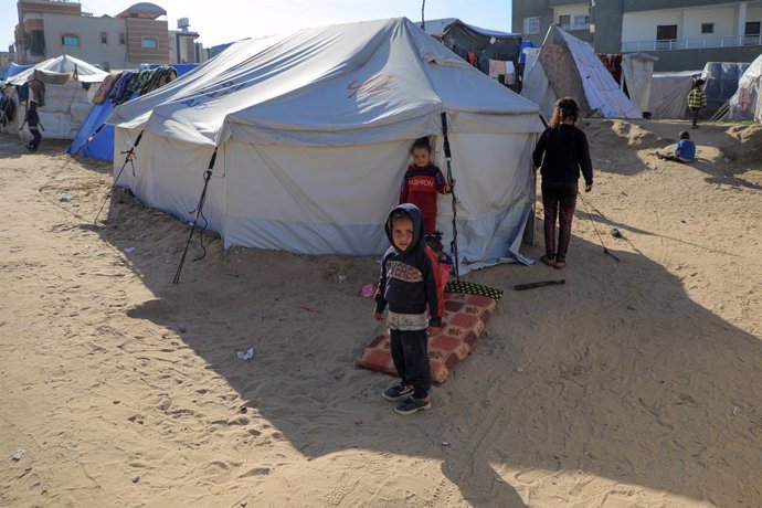 GAZA, March 8, 2024  -- Children are seen in front of a shelter at a temporary camp in the southern Gaza Strip city of Rafah, on March 8, 2024. Commissioner-general of the United Nations Relief and Works Agency for Palestinian Refugees in the Near East (U