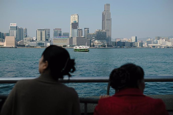 February 10, 2024, Hong Kong, China: Mainland tourists look out to Victoria harbour from Golden Bauhinia Square. The executive director of the Travel Industry Council, predicted the number of visitors from the mainland to Hong Kong would reach about 1.2 m
