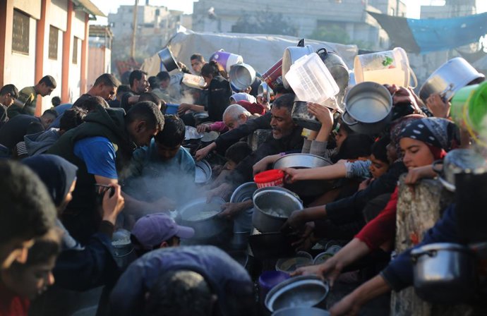GAZA, March 14, 2024  -- People try to get food relief in the southern Gaza Strip city of Rafah, on March 14, 2024. The Palestinian death toll in the Gaza Strip from ongoing Israeli attacks has risen to 31,341, the Hamas-run Health Ministry said in a pr