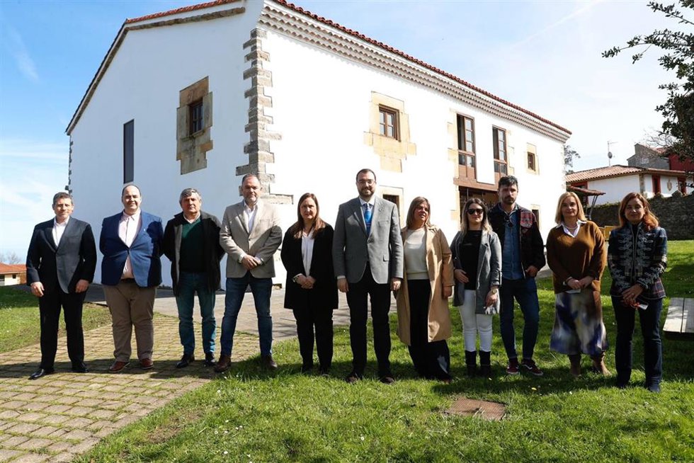 El presidente del Principado, Adrián Barbón, y la vicepresidenta, Gimena Llamedo, con la corporación municipal de Caravia y los responsables de la Cámara de Comercio de Oviedo.