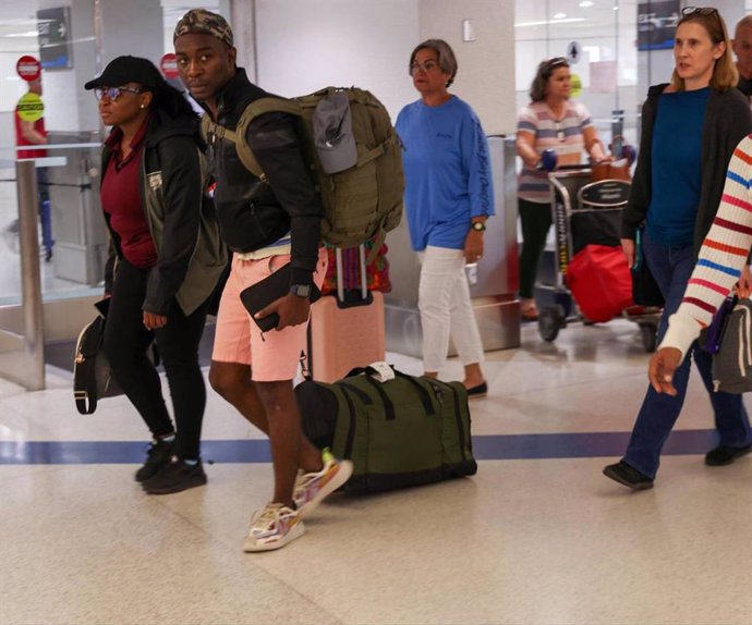 March 17, 2024: Passengers walk through the Arrivals area after arriving on the first evacuation flight out of Cap-Haitien, Haiti, at Miami International Airport on Sunday, March 17, 2024.