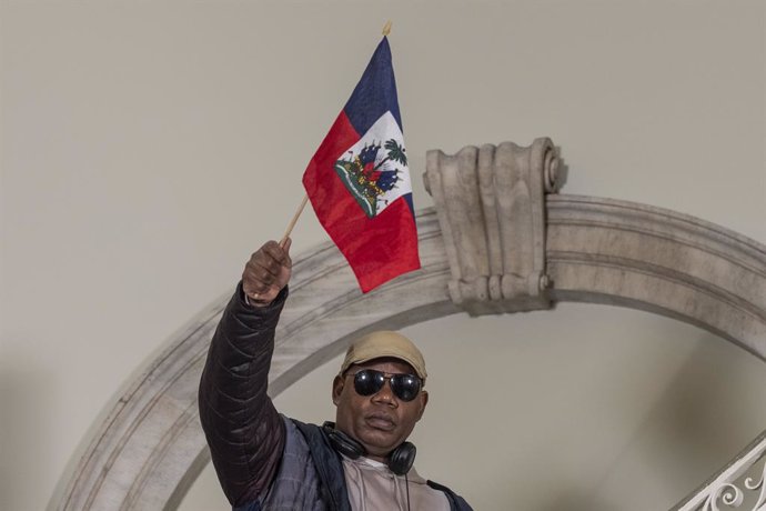 March 20, 2024, New York, New York, USA: An Activist waves a Haitian flag during a rally in support of Haiti at City Hall. Mayor Adams was joined by Reverend Sharpton, religious leaders of different faiths, activists in rally in support of democratic Hait