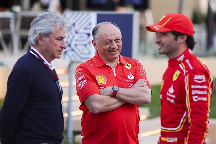 El director de equipo de Ferrari, Fred Vasseur, charla con su piloto Carlos Sainz delante del padre de éste, el también piloto Carlos Sainz