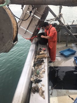 Un pescador recoge residuos del mar