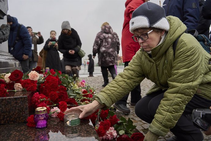 VLADIVOSTOK, March 23, 2024  -- A woman lays a candle to commemorate victims of Moscow terrorist attack during a memorial event in Vladivostok, Russia, March 23, 2024. Death toll has risen to 93 people in Friday's terrorist attack after gunmen stormed a c